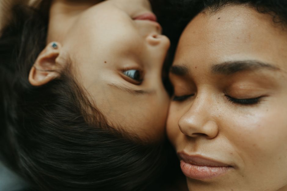 A heartfelt close-up capturing a mother and child embracing in a serene, loving moment.
